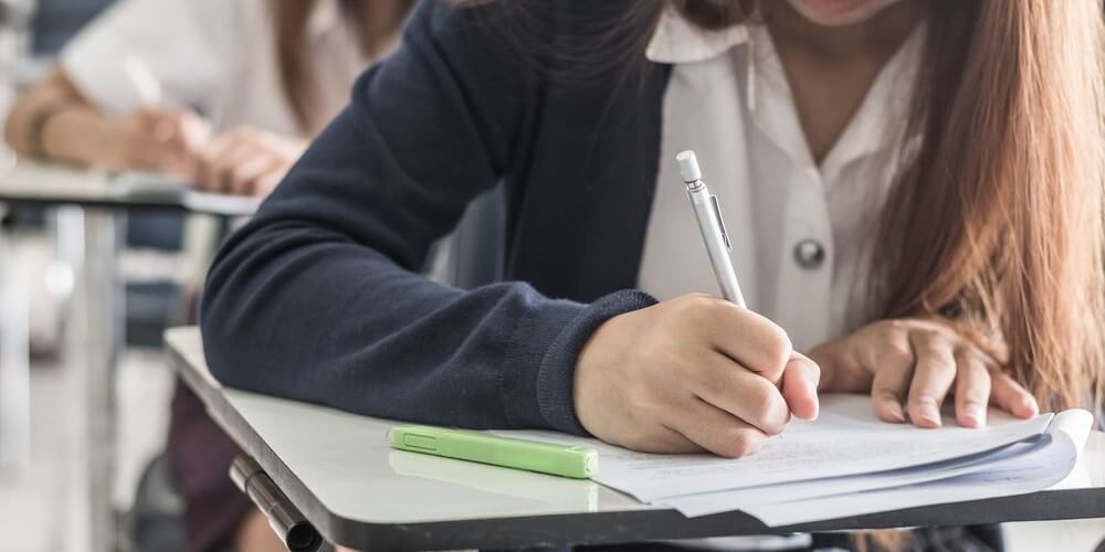 Female student taking psychology exam in classroom