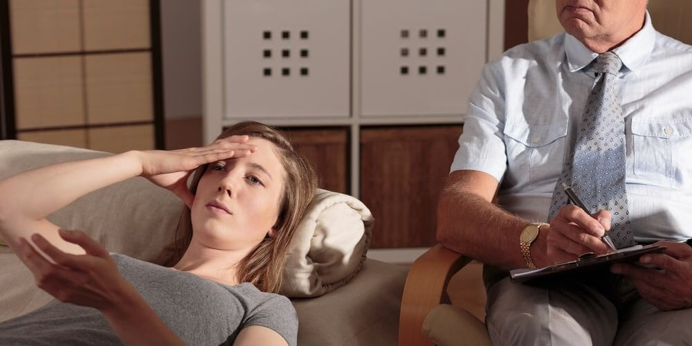 Young woman during therapy session with psychologist