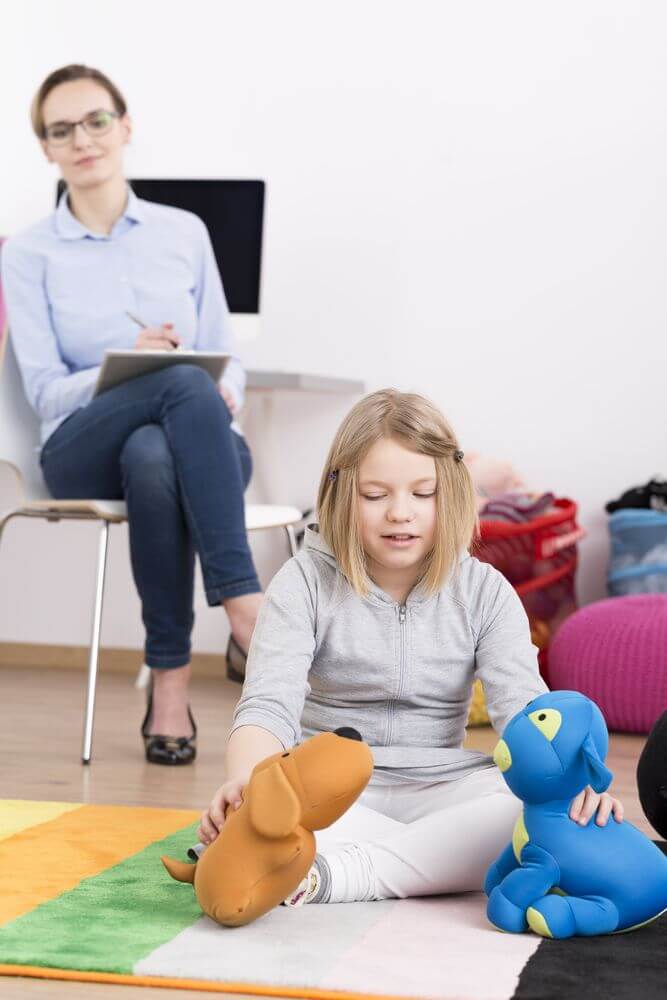 Child Psychologist Watching Her Patient After Getting Her Degree Online