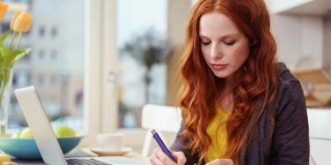 Young woman listening to online psychology class