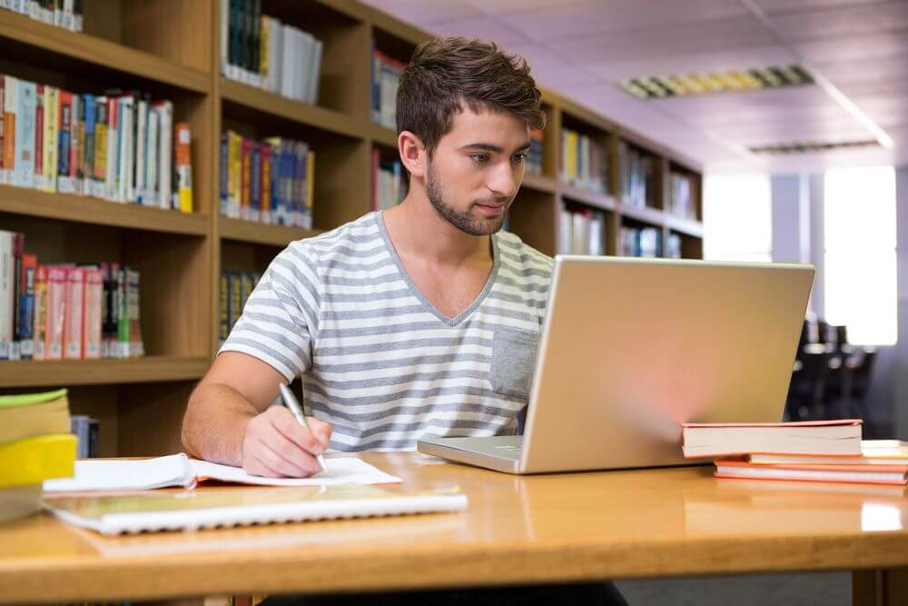 Idaho Student Studying For Online Psychology Doctorate Degree in Library