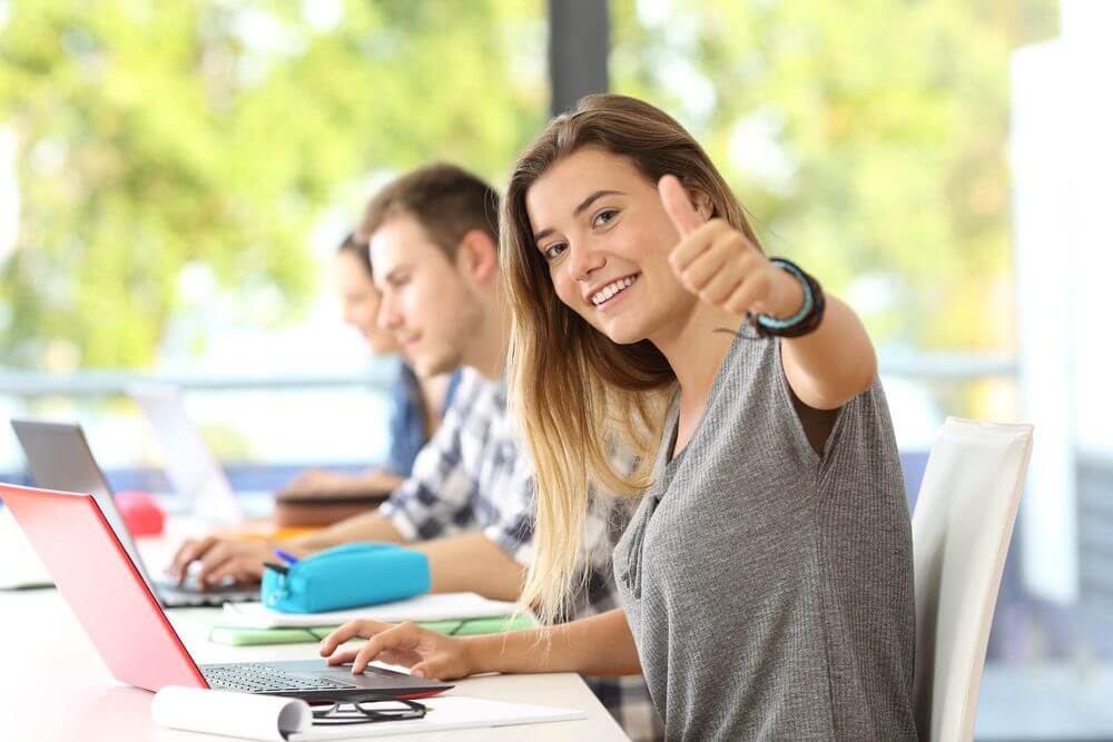 Ohio Student Giving Thumbs Up While Studying Online For Clinical Psychology Degree