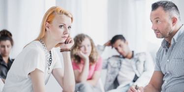 Young woman with red hair in anger group therapy session