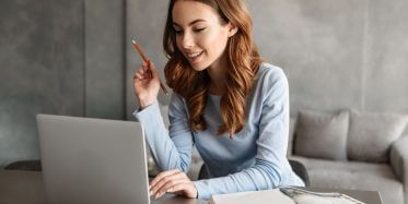 Woman taking online Psychology class from hotel