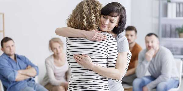 Women Hugging In Group Therapy