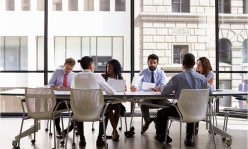 Group of businesspeople talking around a table