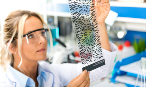 Woman holding a sheet of genetic information