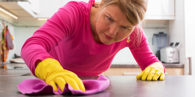 Concerned woman cleaning a counter